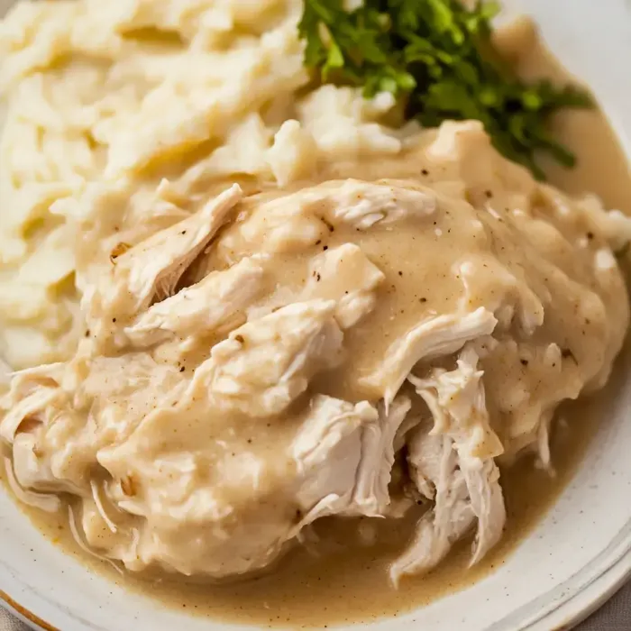 A plate of food with chicken and mashed potatoes.
