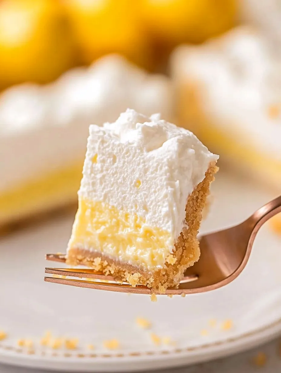 A piece of lemon lasagna on a fork.