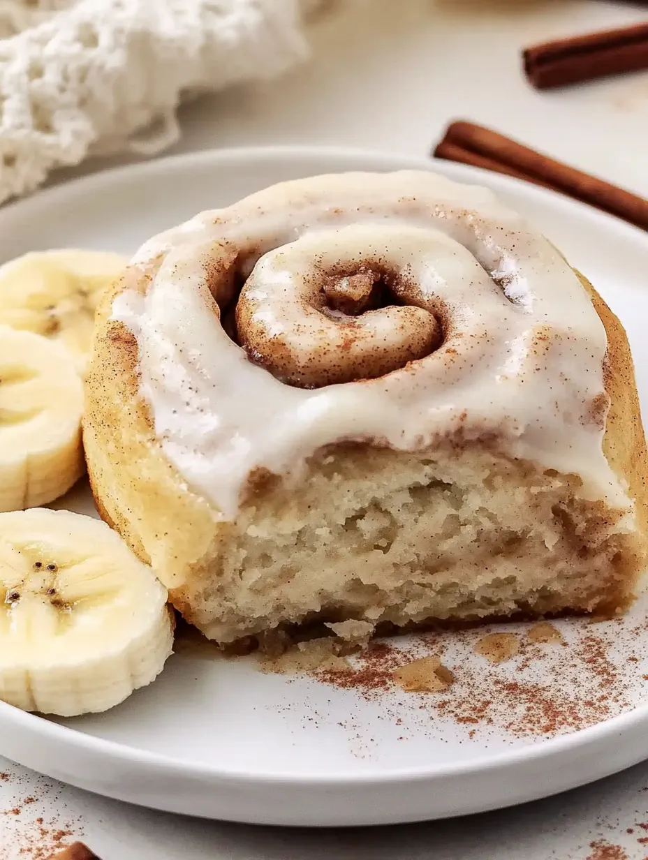 A plate of cinnamon rolls and bananas.
