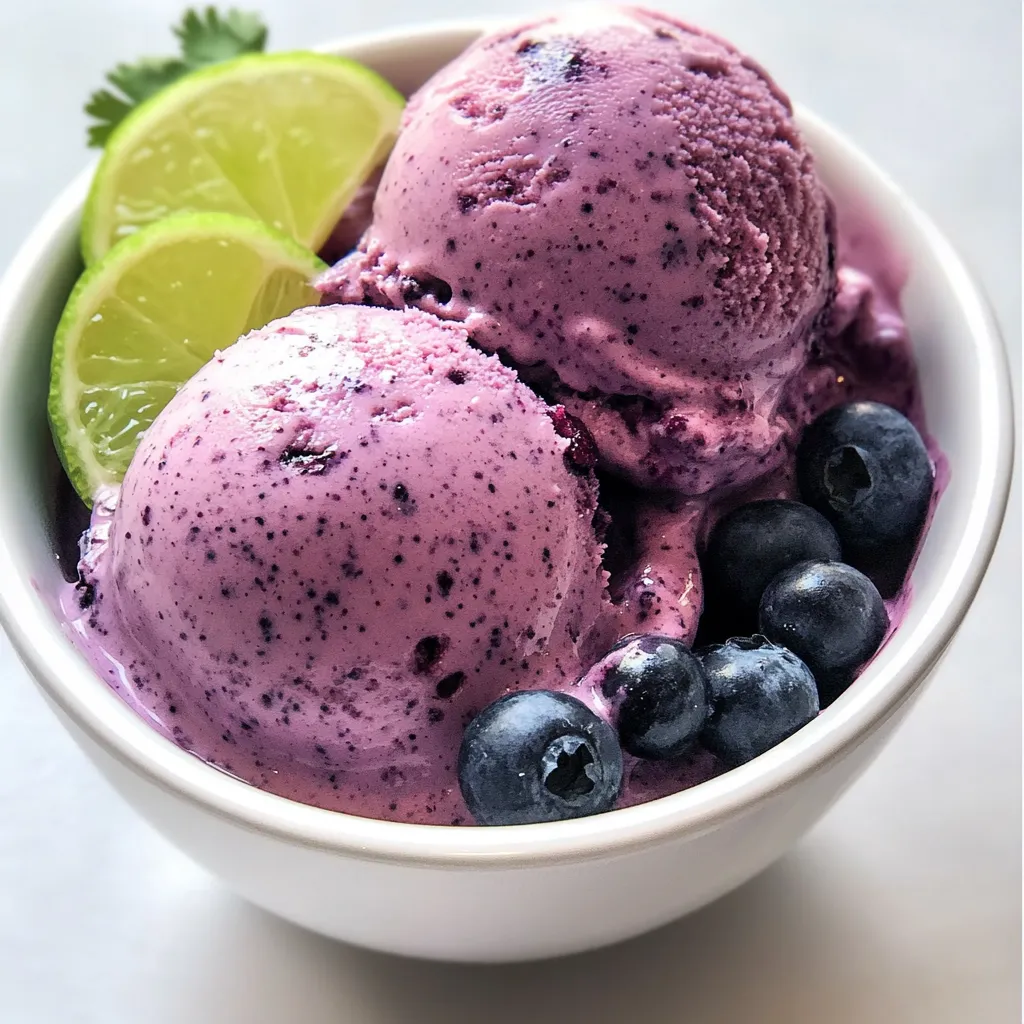 A bowl of yogurt with blueberries and limes.
