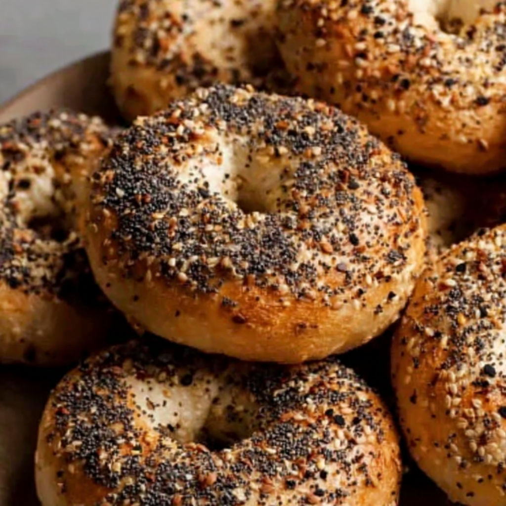 A plate of bagels with poppy seeds.