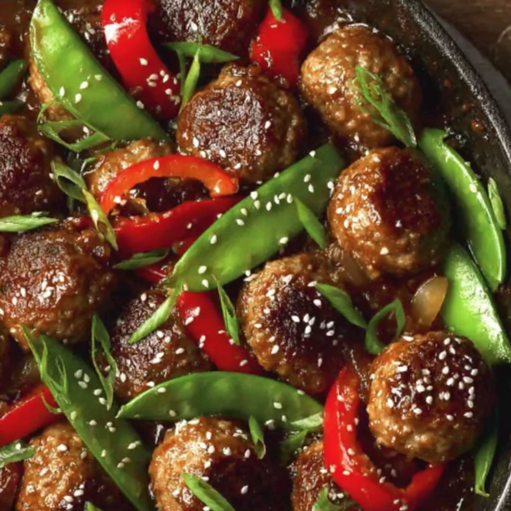 A dish of meatballs with a sweet and savory sauce.