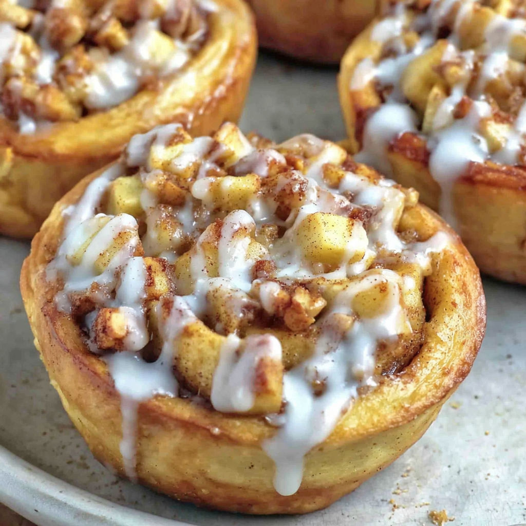 A pastry with white icing and brown sugar.
