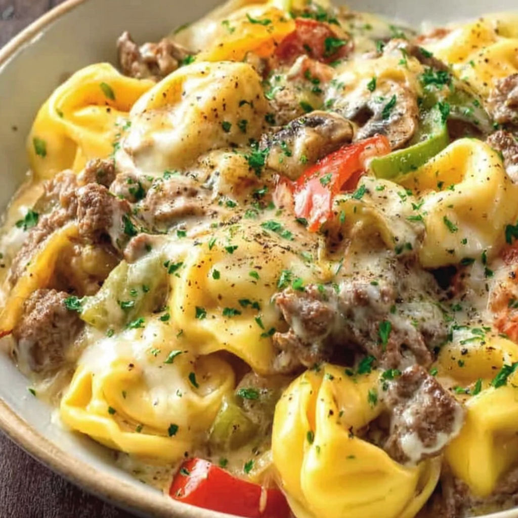 A bowl of food with cheese and tomatoes.