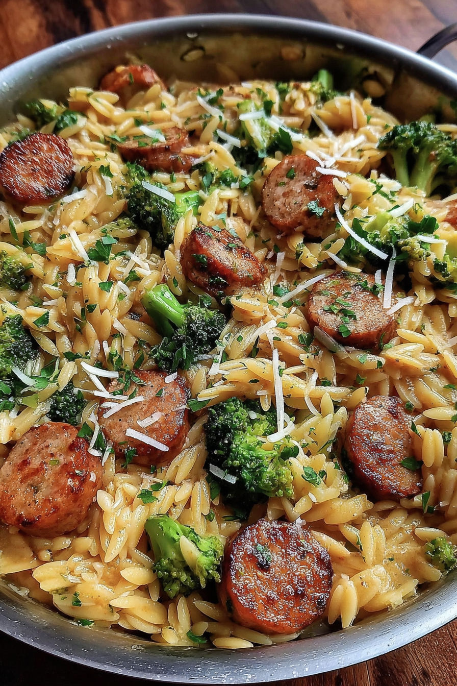 A dish of chicken sausage and broccoli orzo.