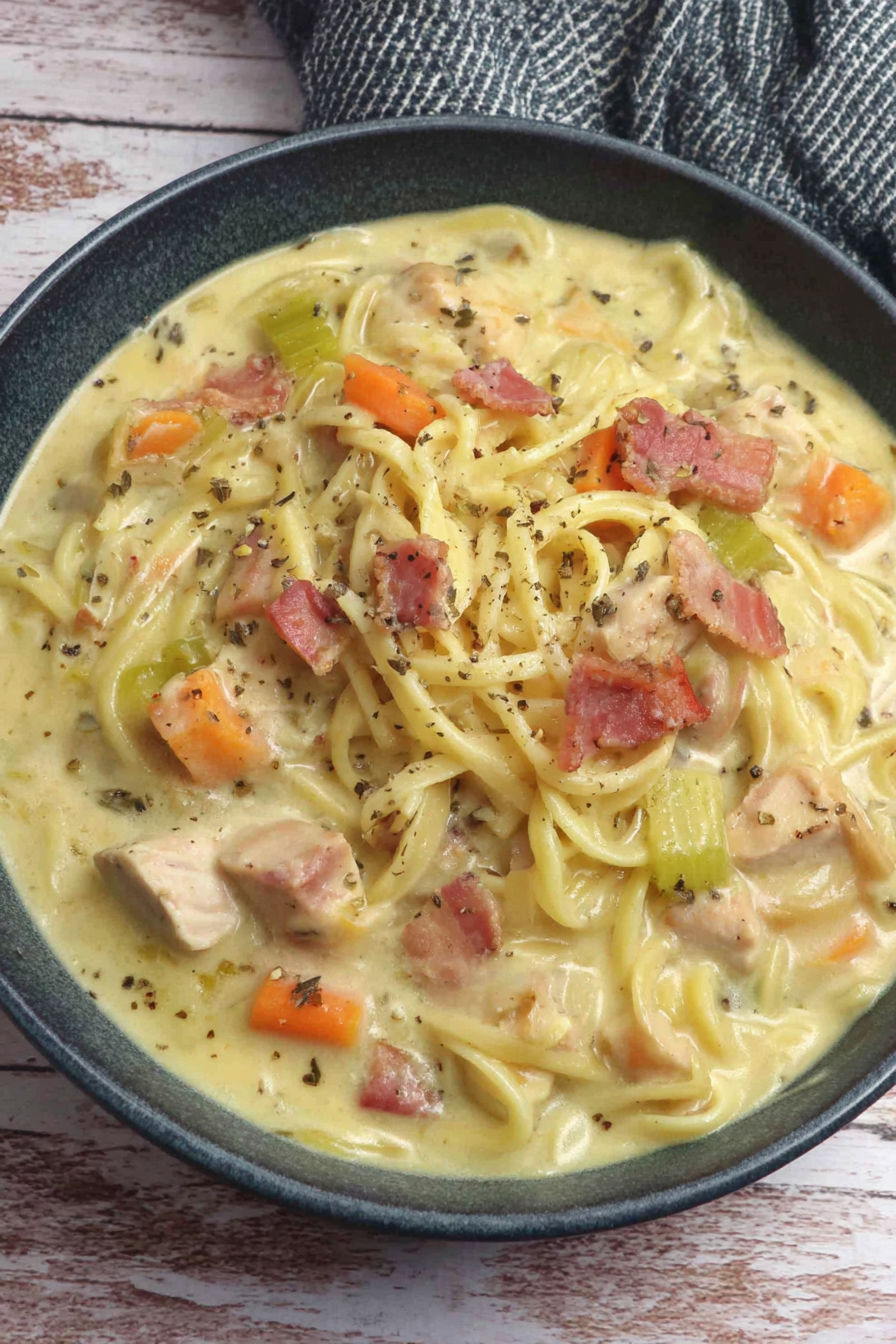 A bowl of soup with noodles and meat.