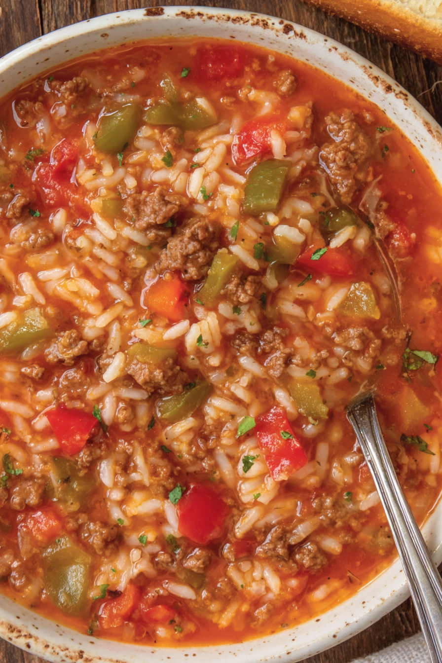 A bowl of soup with rice and meat.