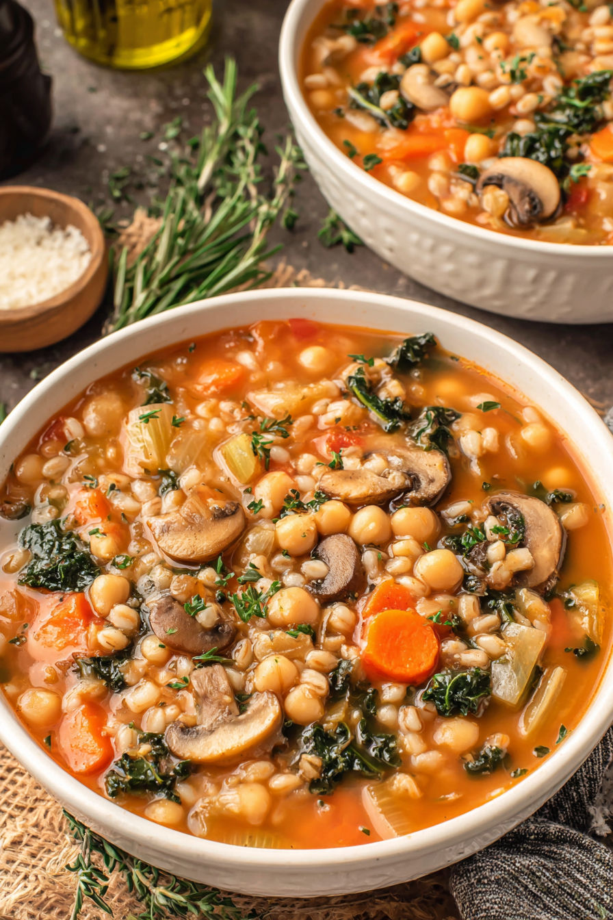A bowl of soup with mushrooms and carrots.