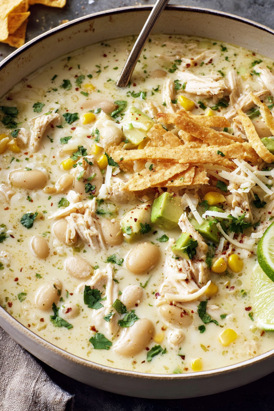 A bowl of soup with chicken, beans, and corn.