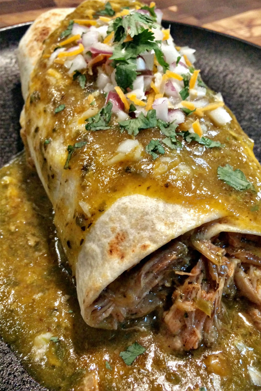 A chili verde hatch burrito with onions and cheese.