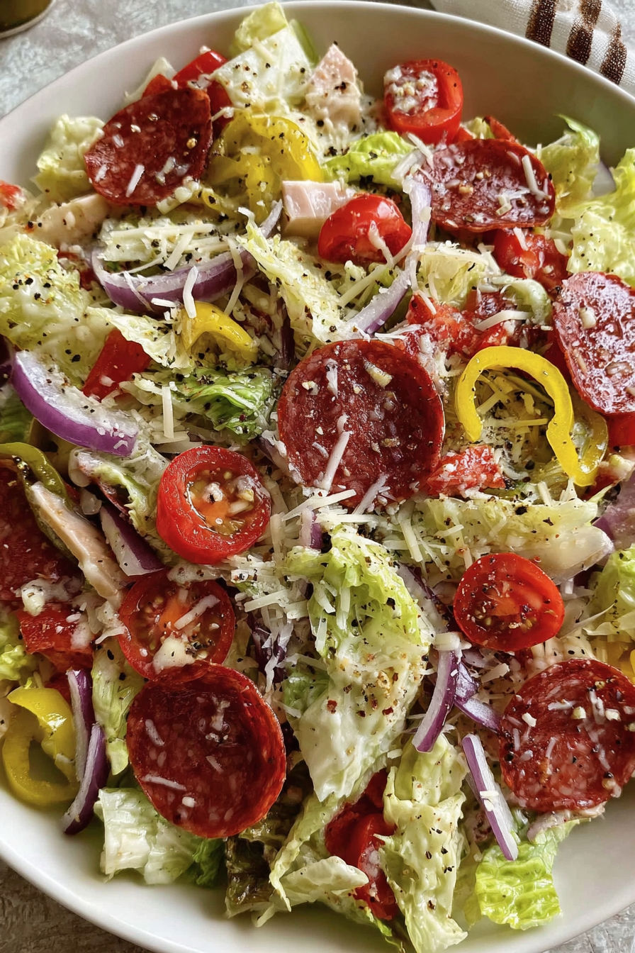 A salad with tomatoes, onions, and peppers.