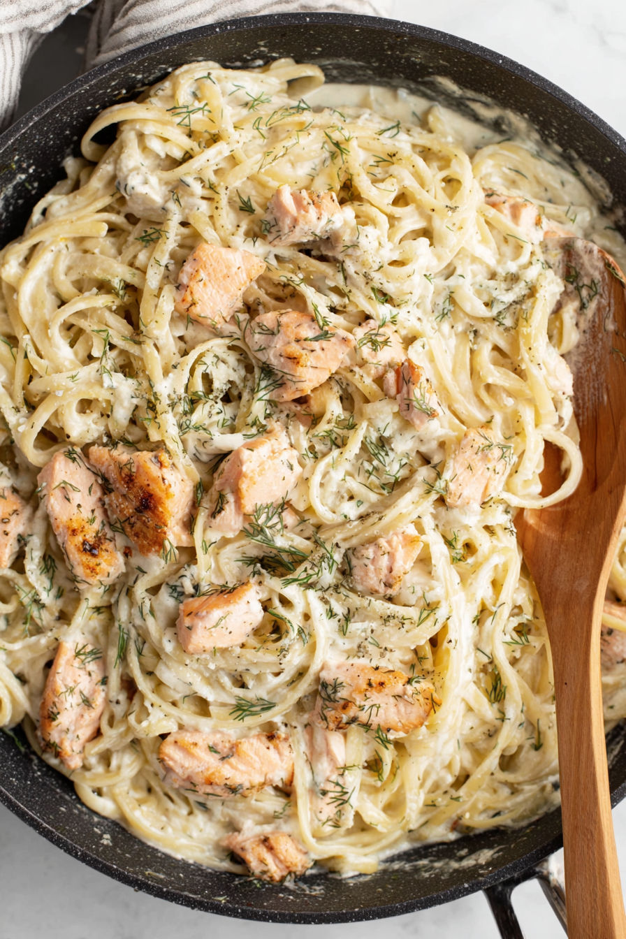 A bowl of pasta with chicken and dill.