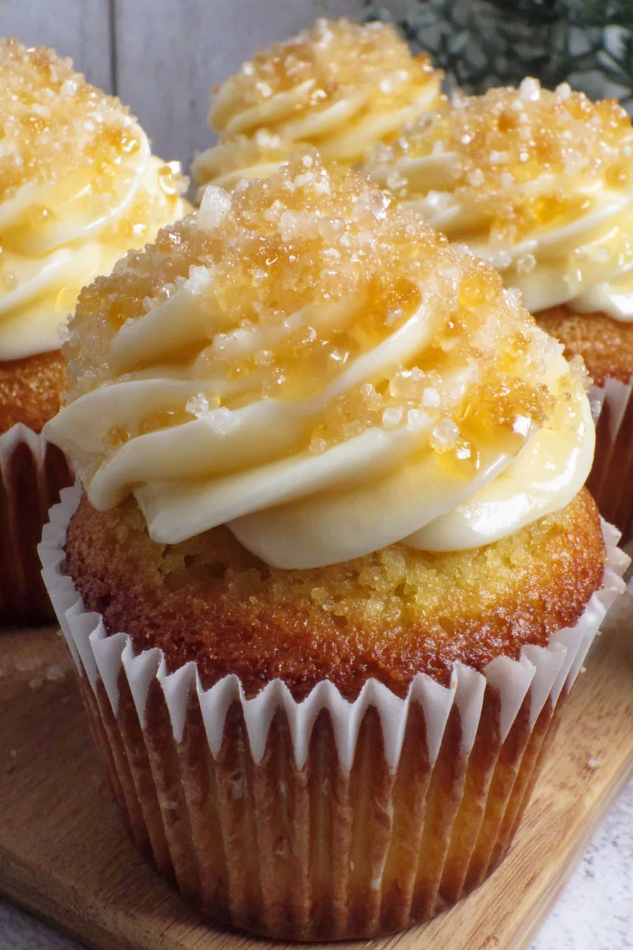 A cupcake with a yellow frosting and white frosting.
