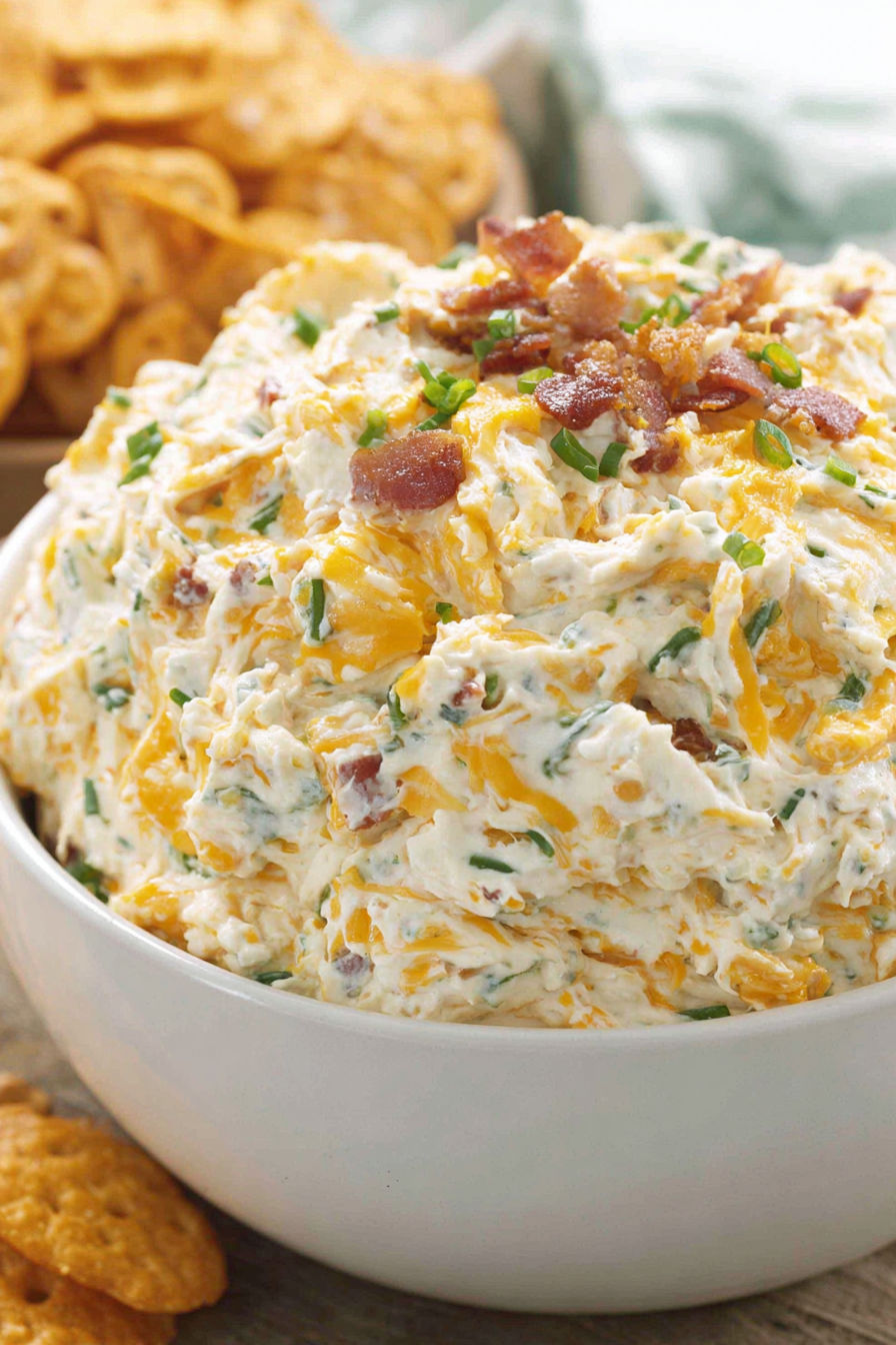 A bowl of loaded baked potato dip.