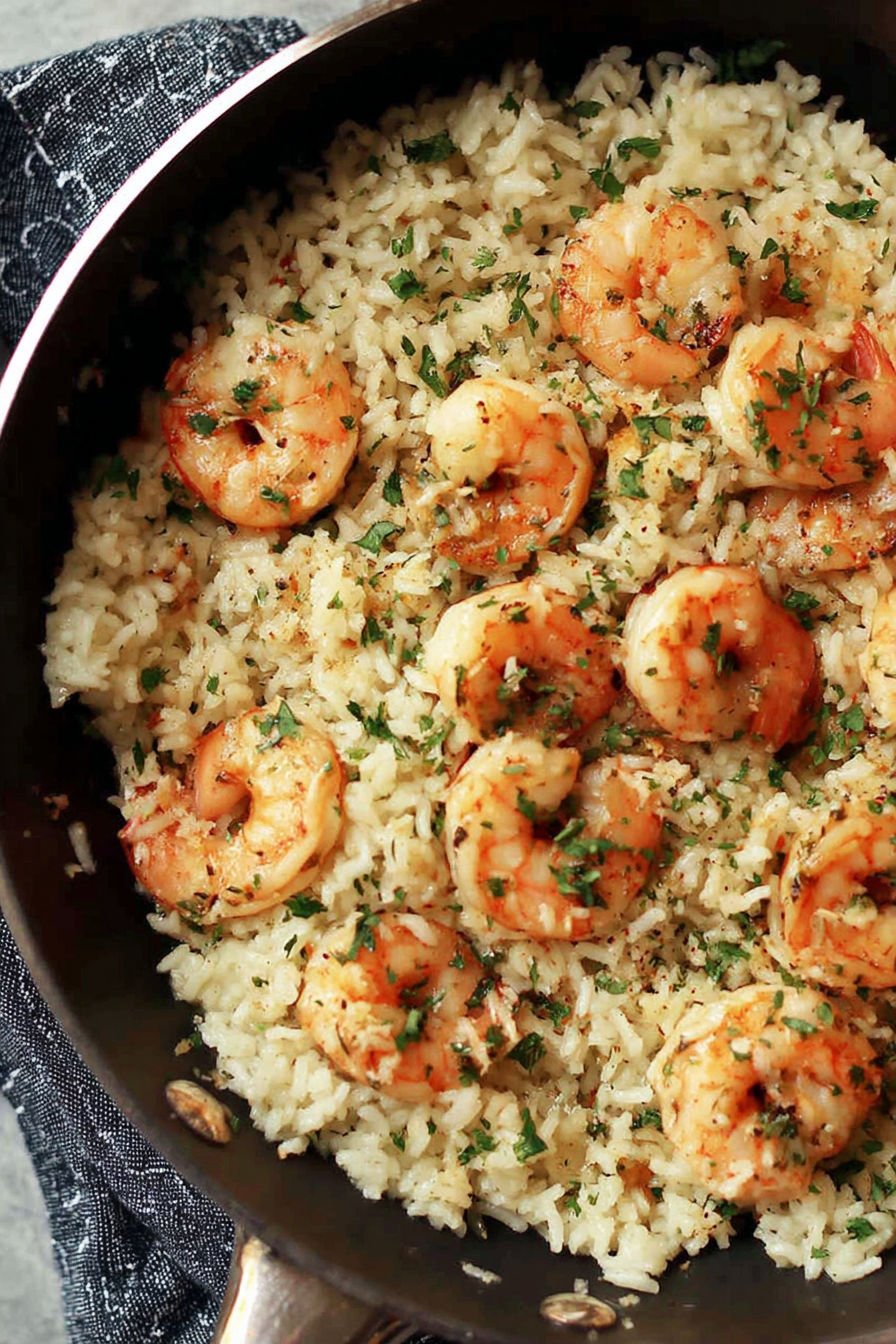A dish of garlic butter shrimp and rice.