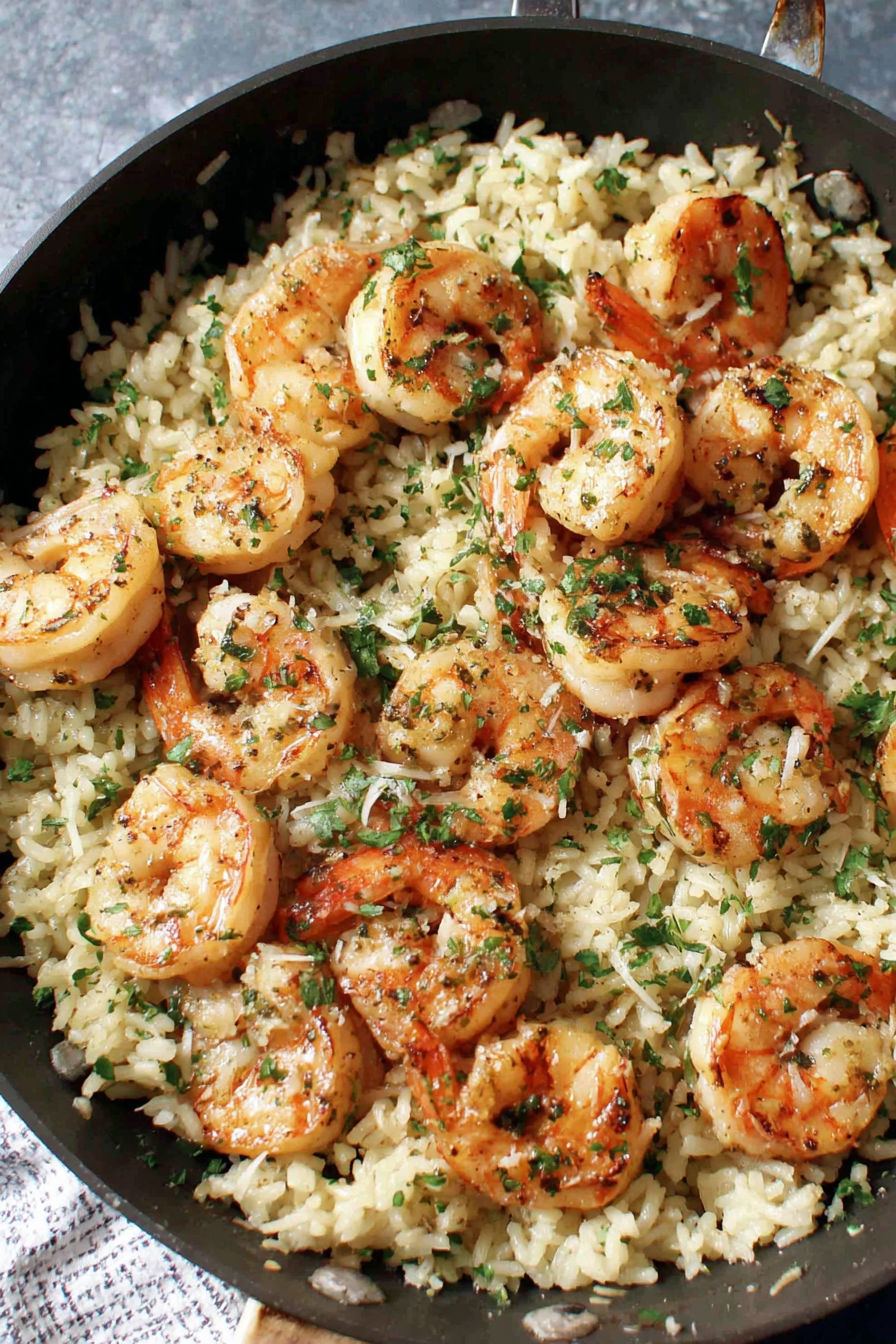 A bowl of shrimp and rice with garlic butter.