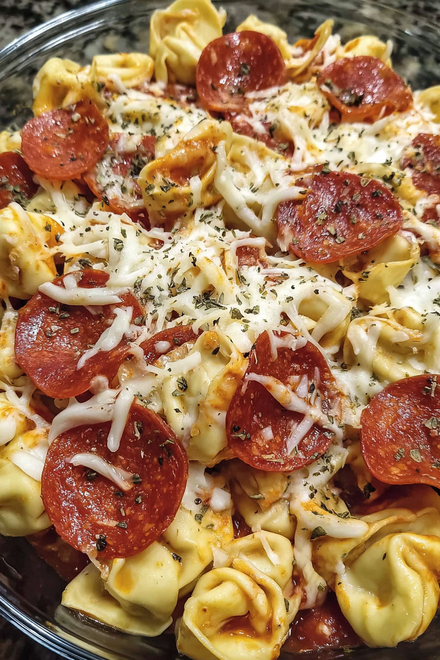 A close up of a pizza with pepperoni and cheese.