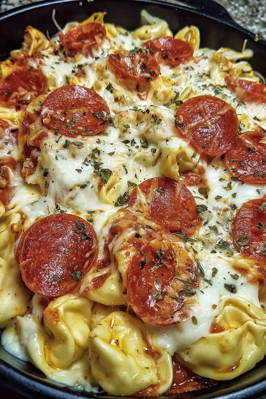A close up of a pizza with pepperoni and cheese.
