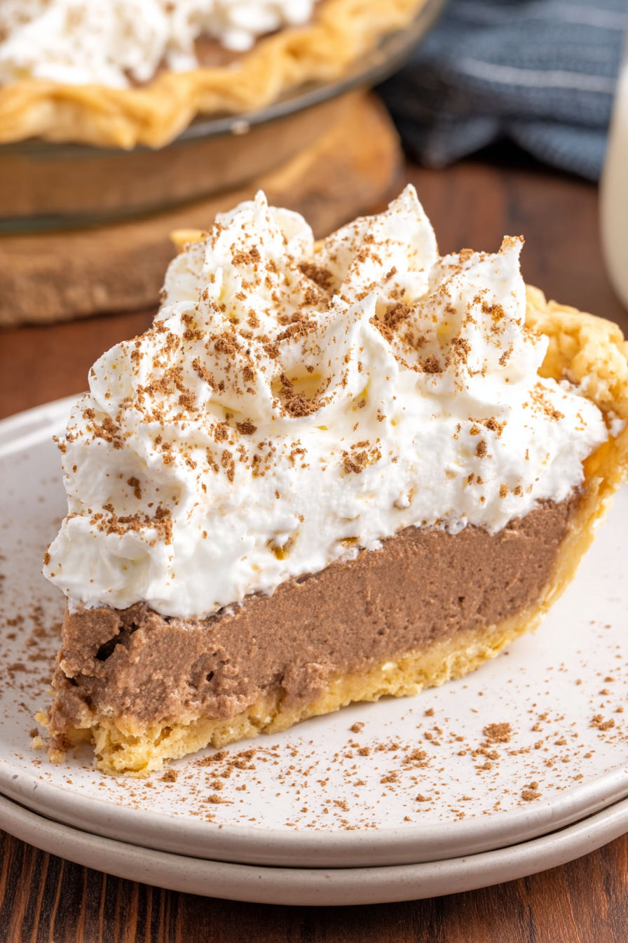 A slice of cinnamon pie with whipped cream on top.