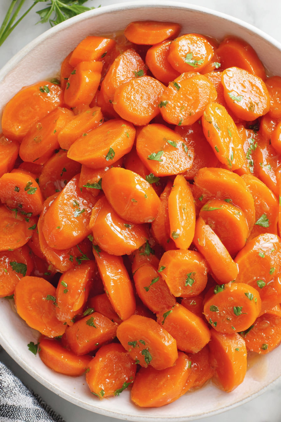 A bowl of cooked carrots.