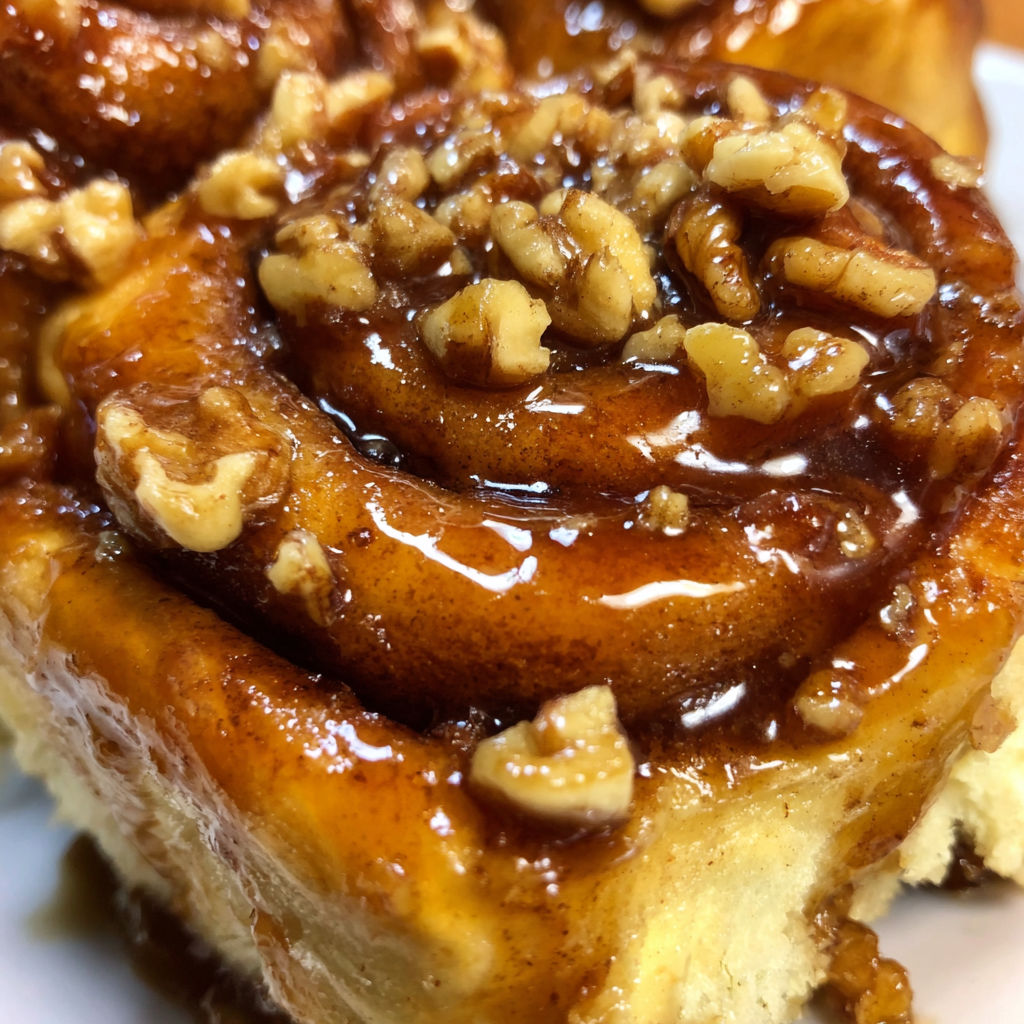 A sticky bun with walnuts and cinnamon.