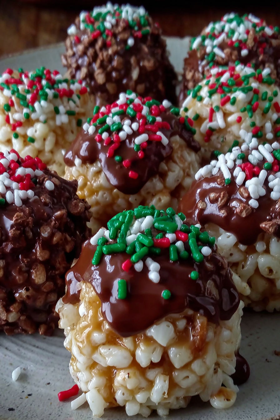 A plate of chocolate covered marshmallows.