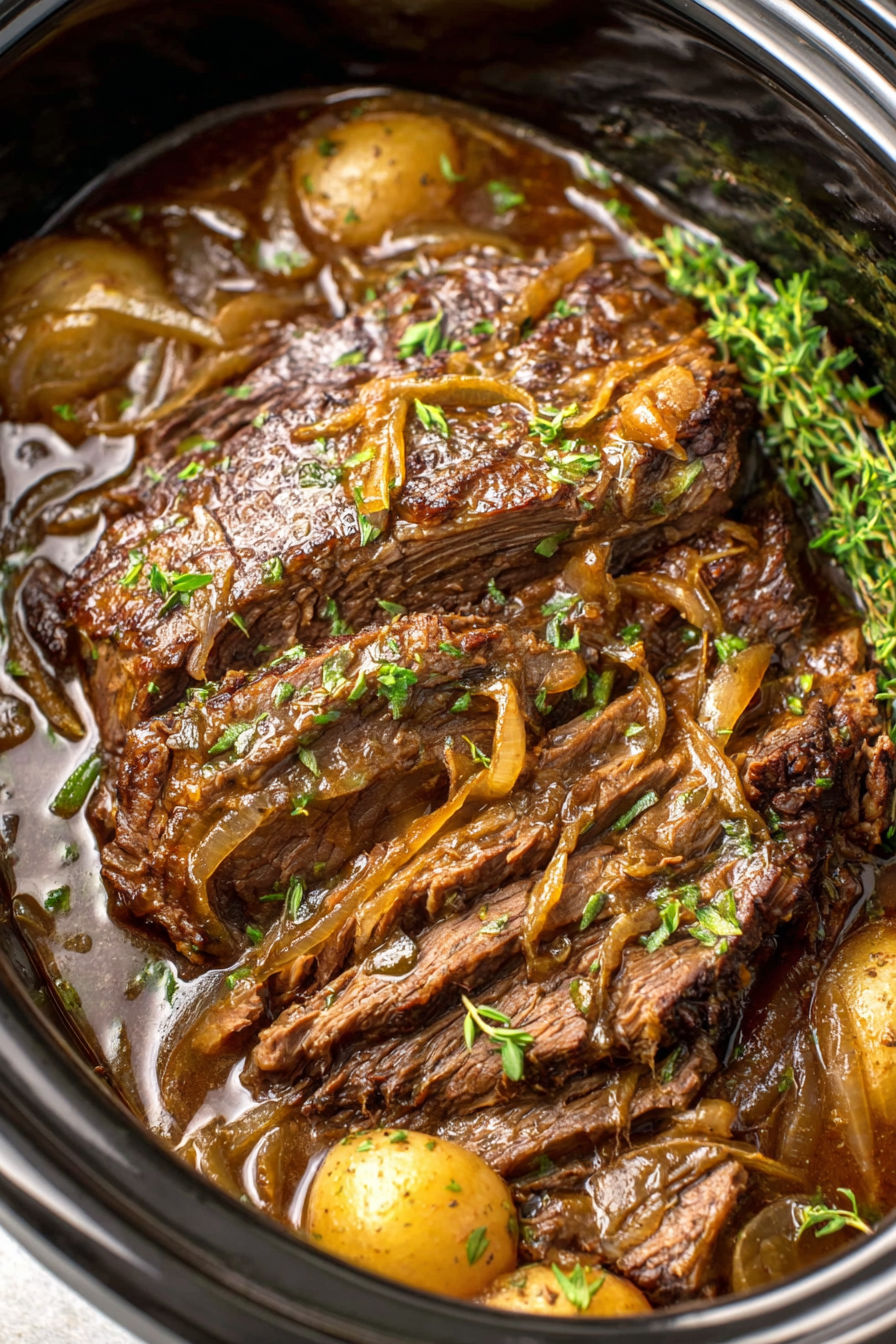 A close up of a beef stew with onions.