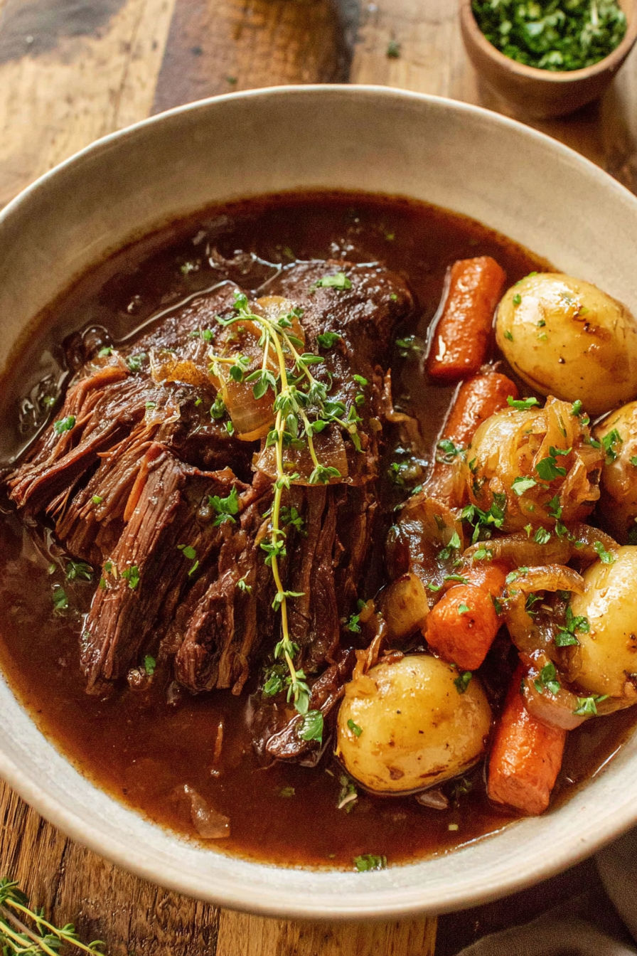 A pot roast with carrots and potatoes.