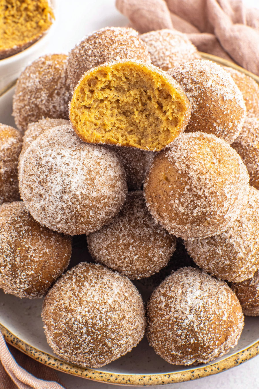 Pumpkin donut holes on a plate.