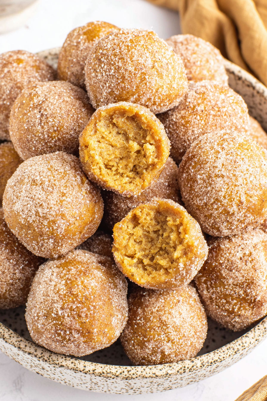 Pumpkin donut holes in a bowl.