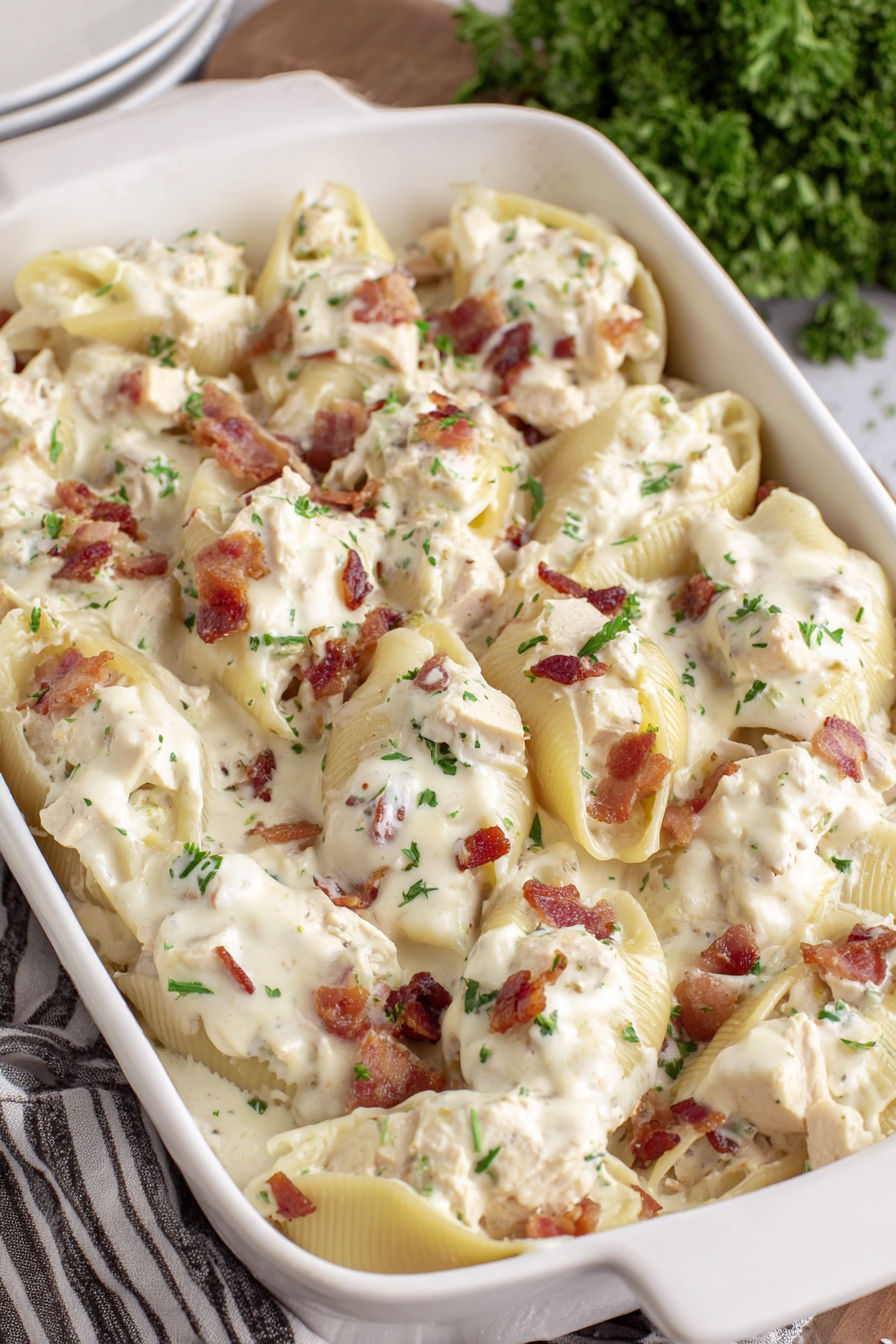 A dish of chicken alfredo stuffed shells.
