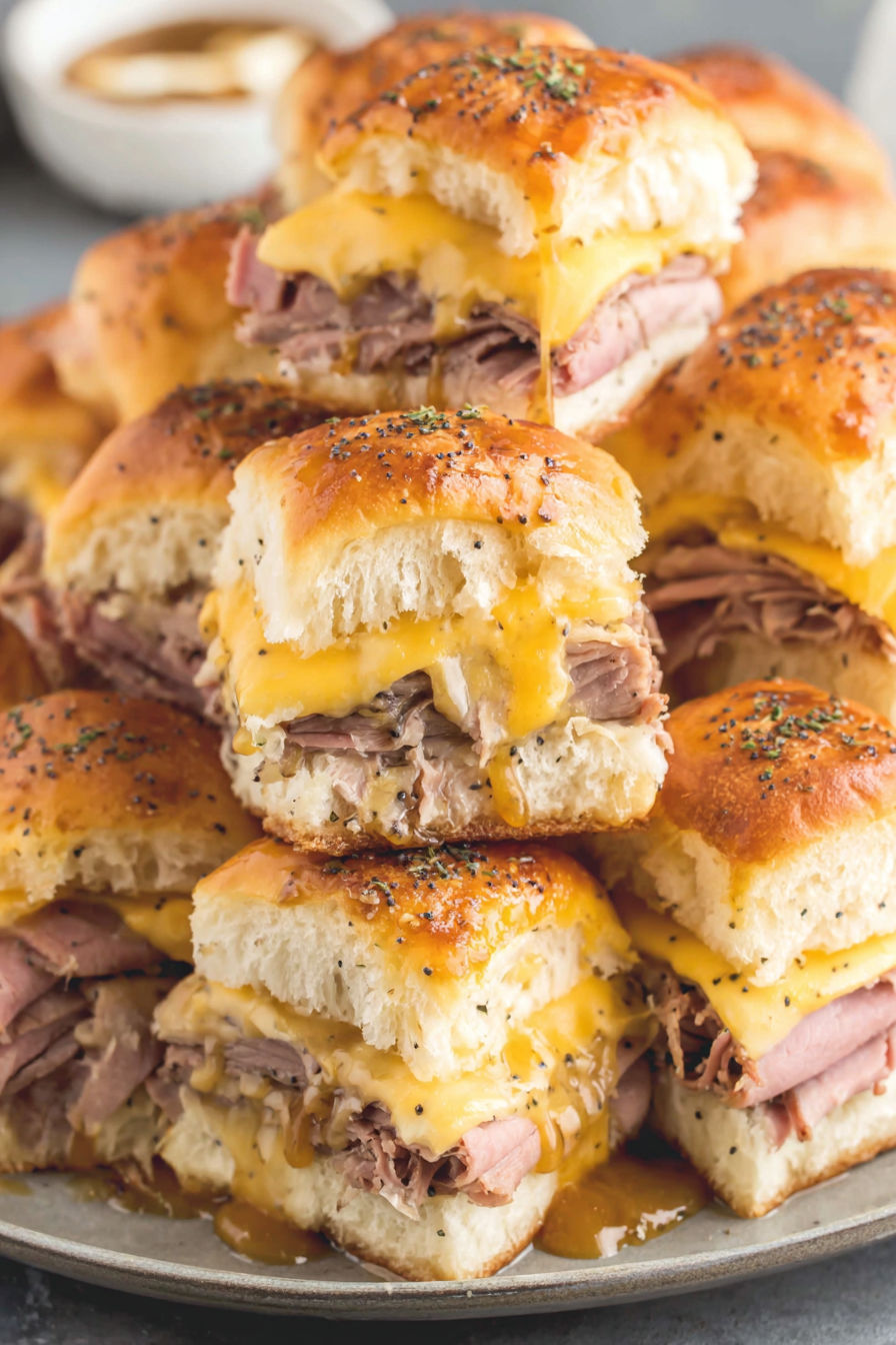 Roast beef sliders with cheese.