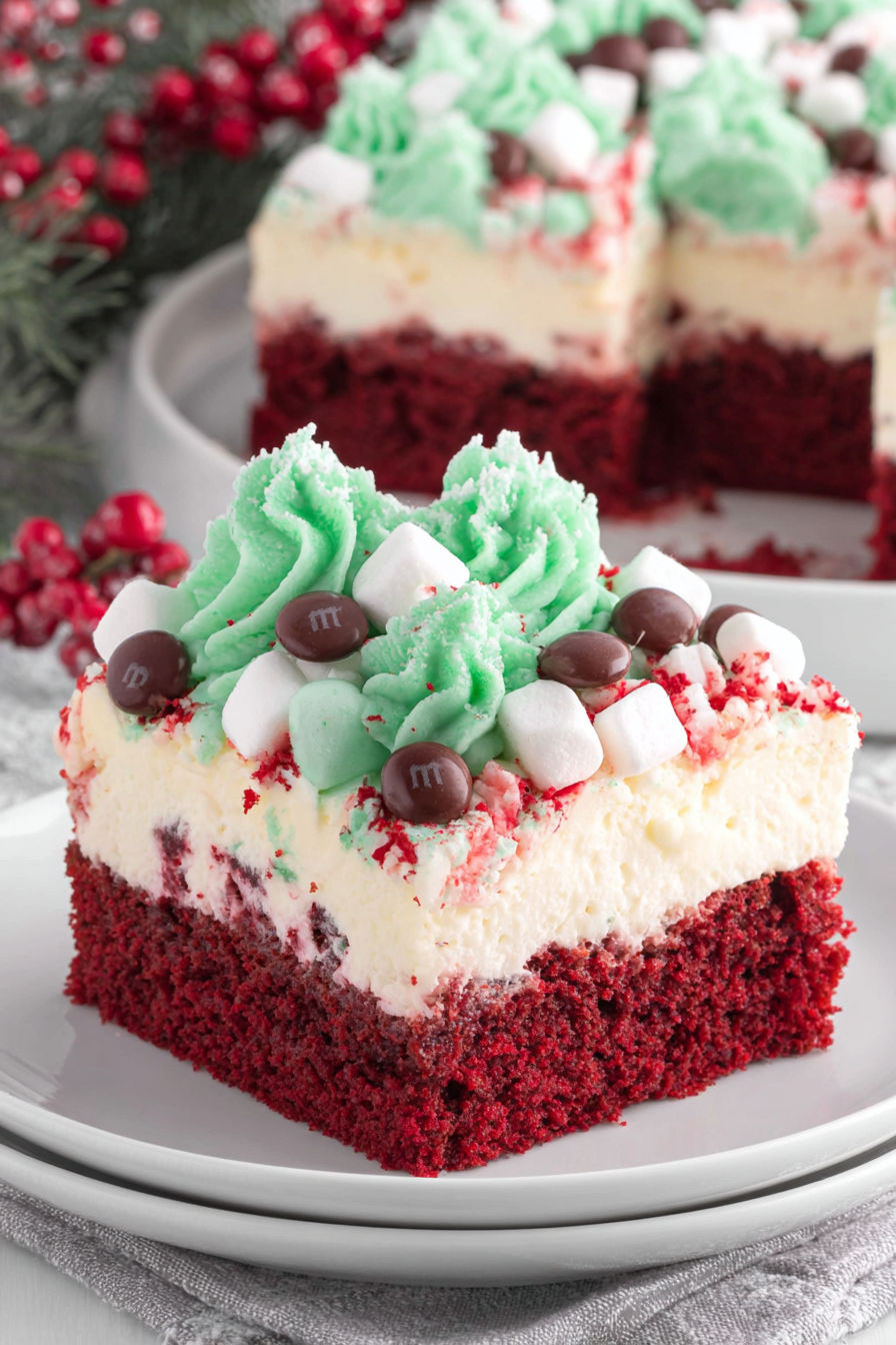 A slice of red velvet cake with white cream and marshmallows.