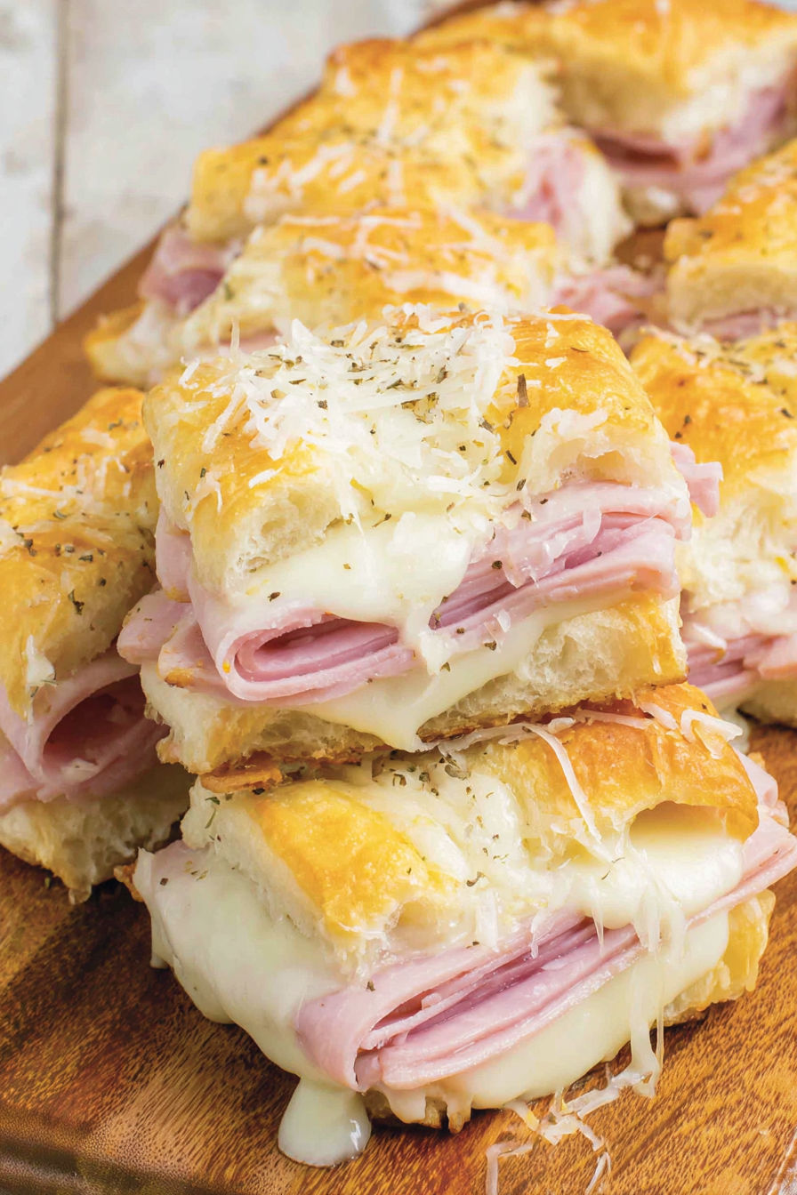 A close up of a baked ham and cheese sandwich.