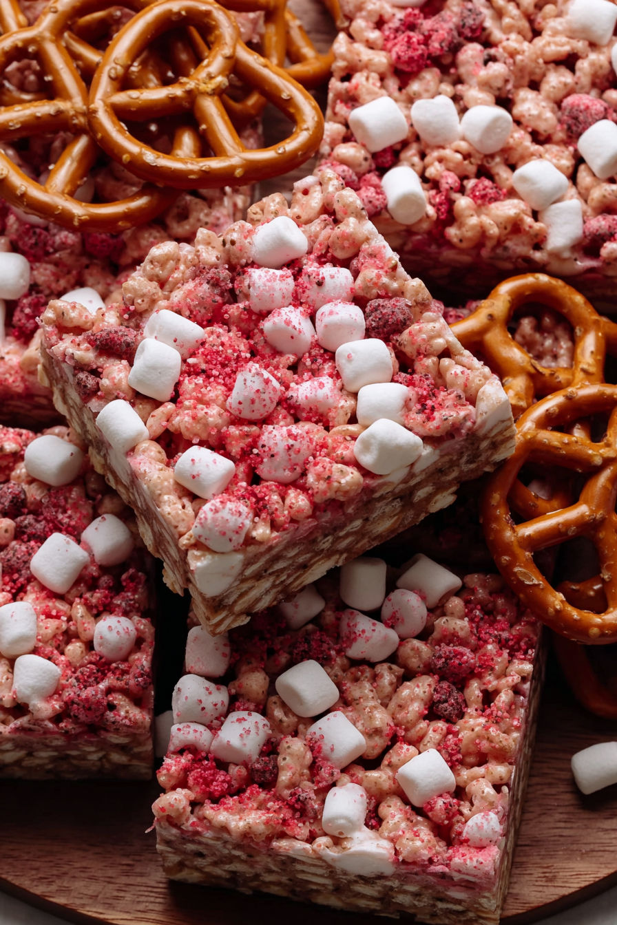 Marshmallows, pretzels, and strawberries are combined to create a delicious treat.