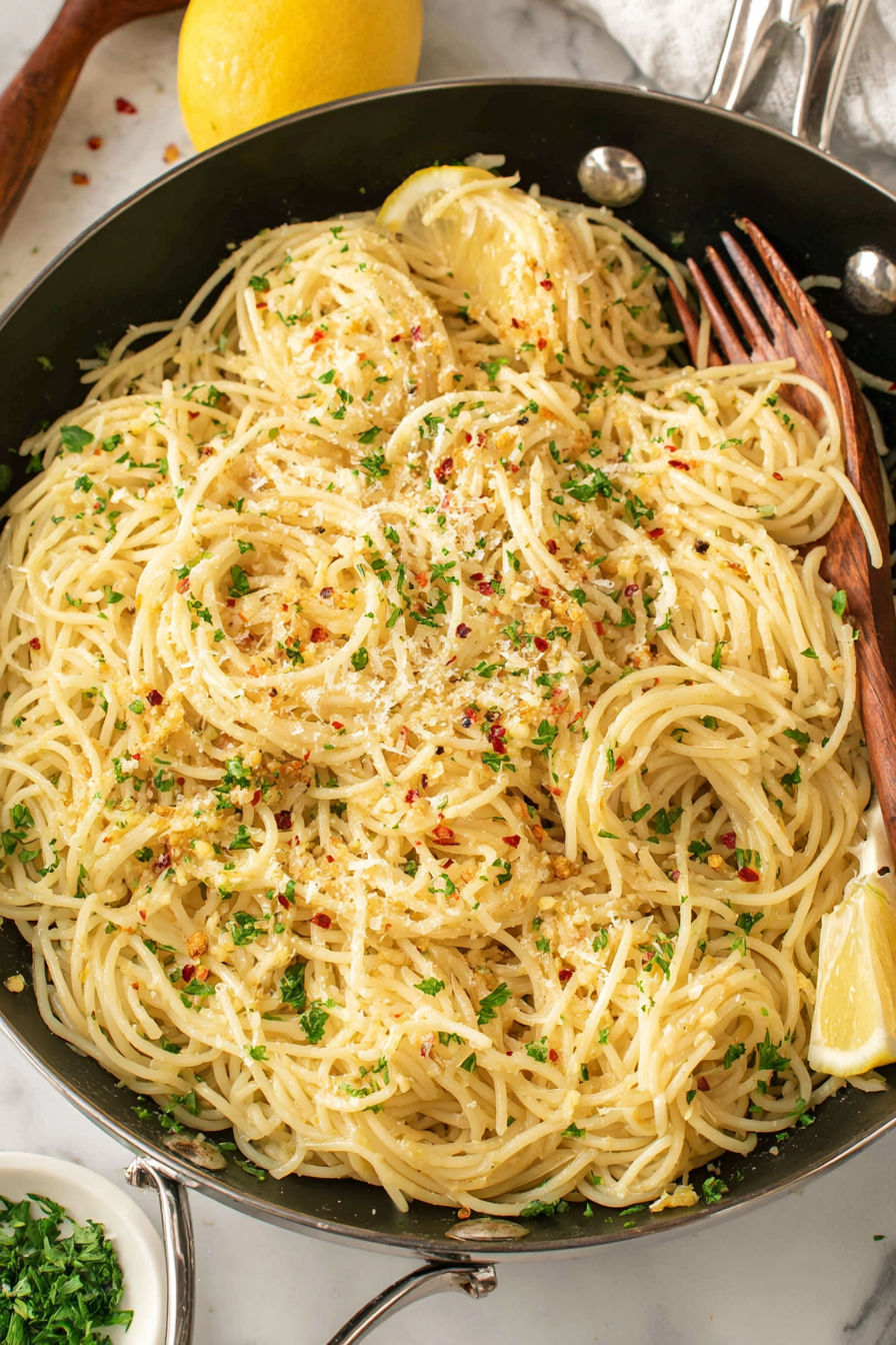 A bowl of Parmesan noodles with a fork on the side.