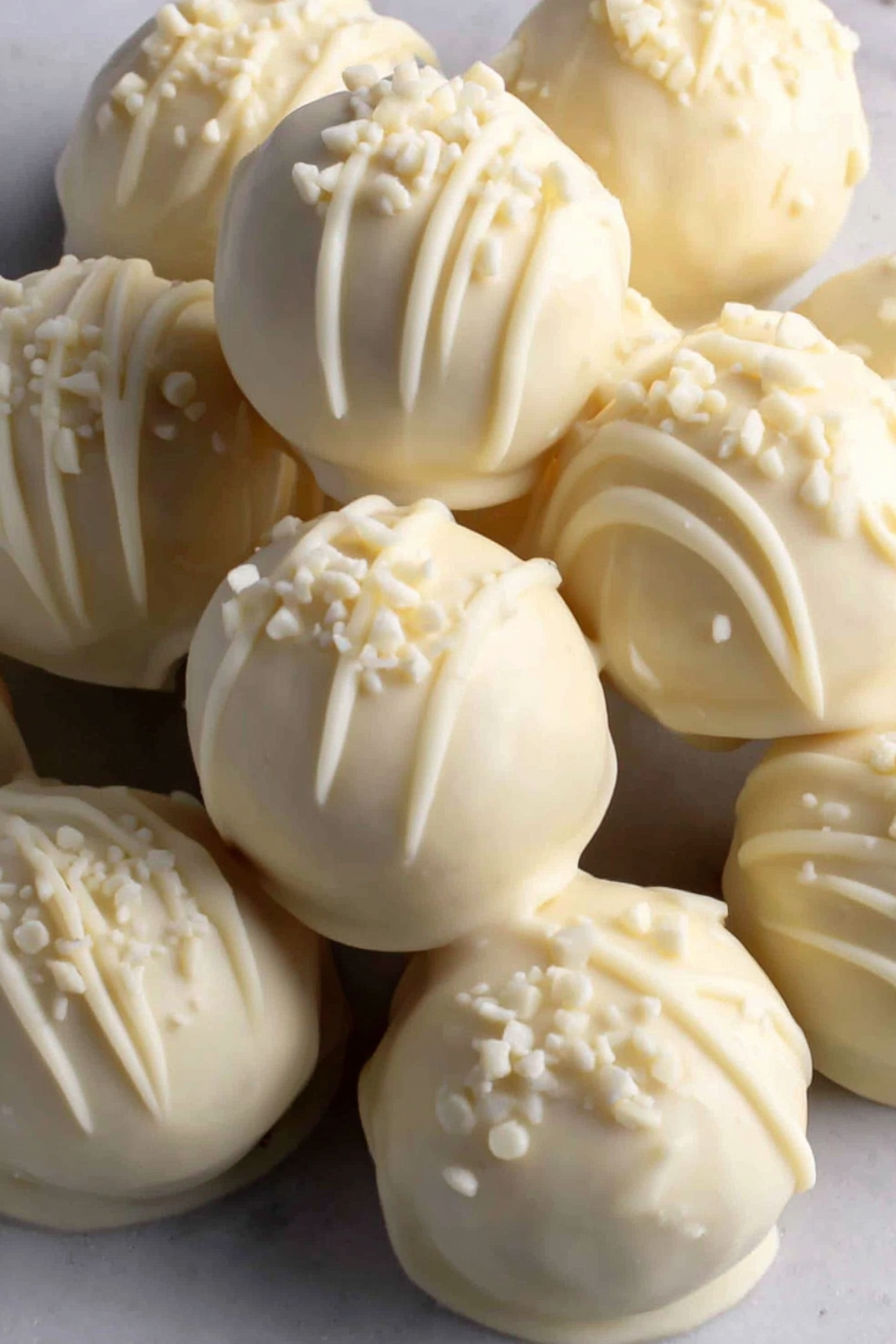 A plate of white balls with powdered sugar.