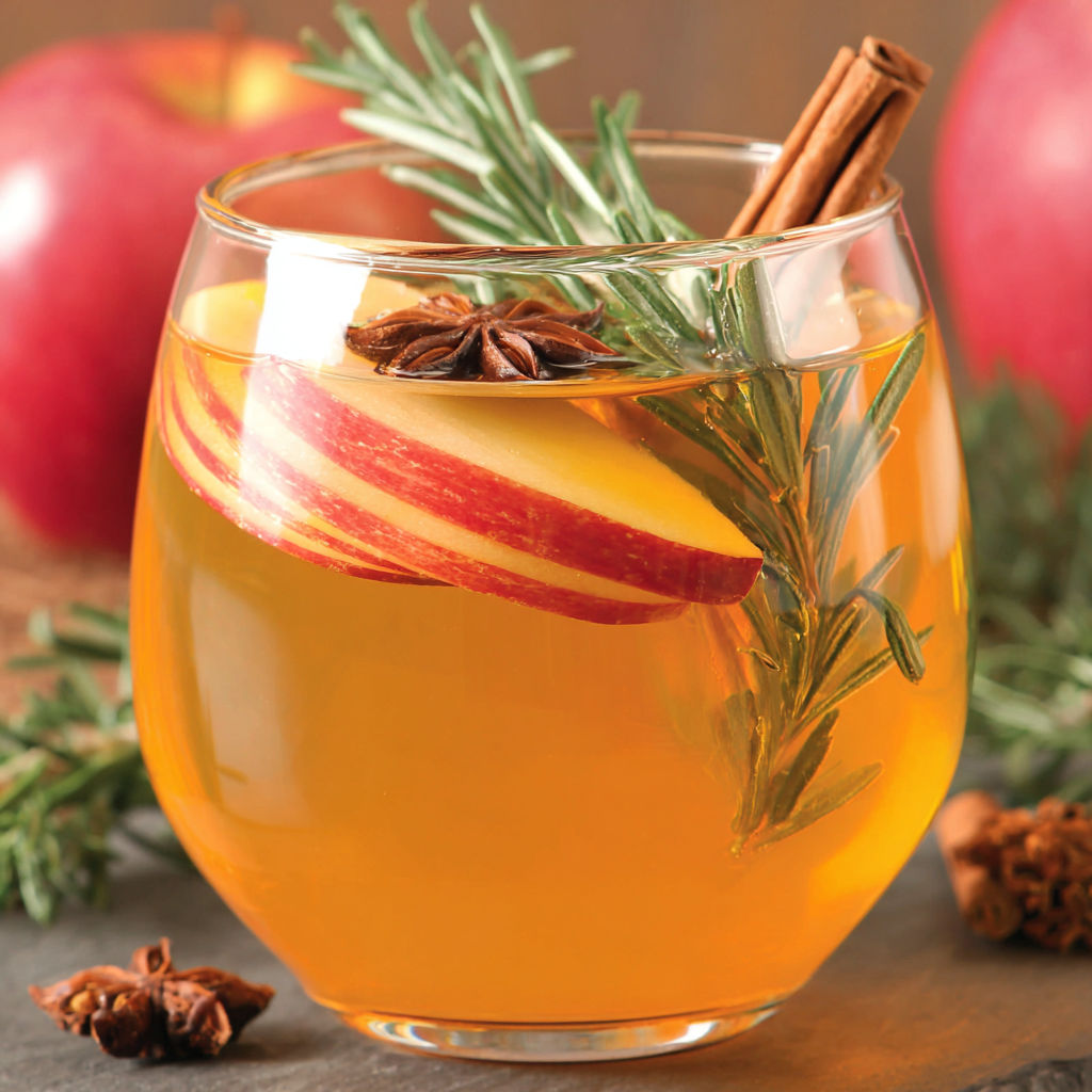 A glass of boozy fireball apple cider.