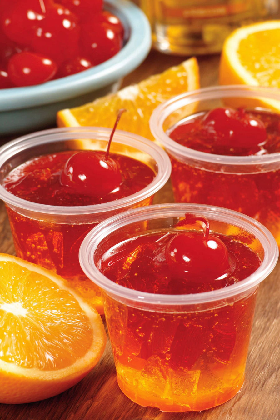 Four cups of Tequila Sunrise Jello Shots.