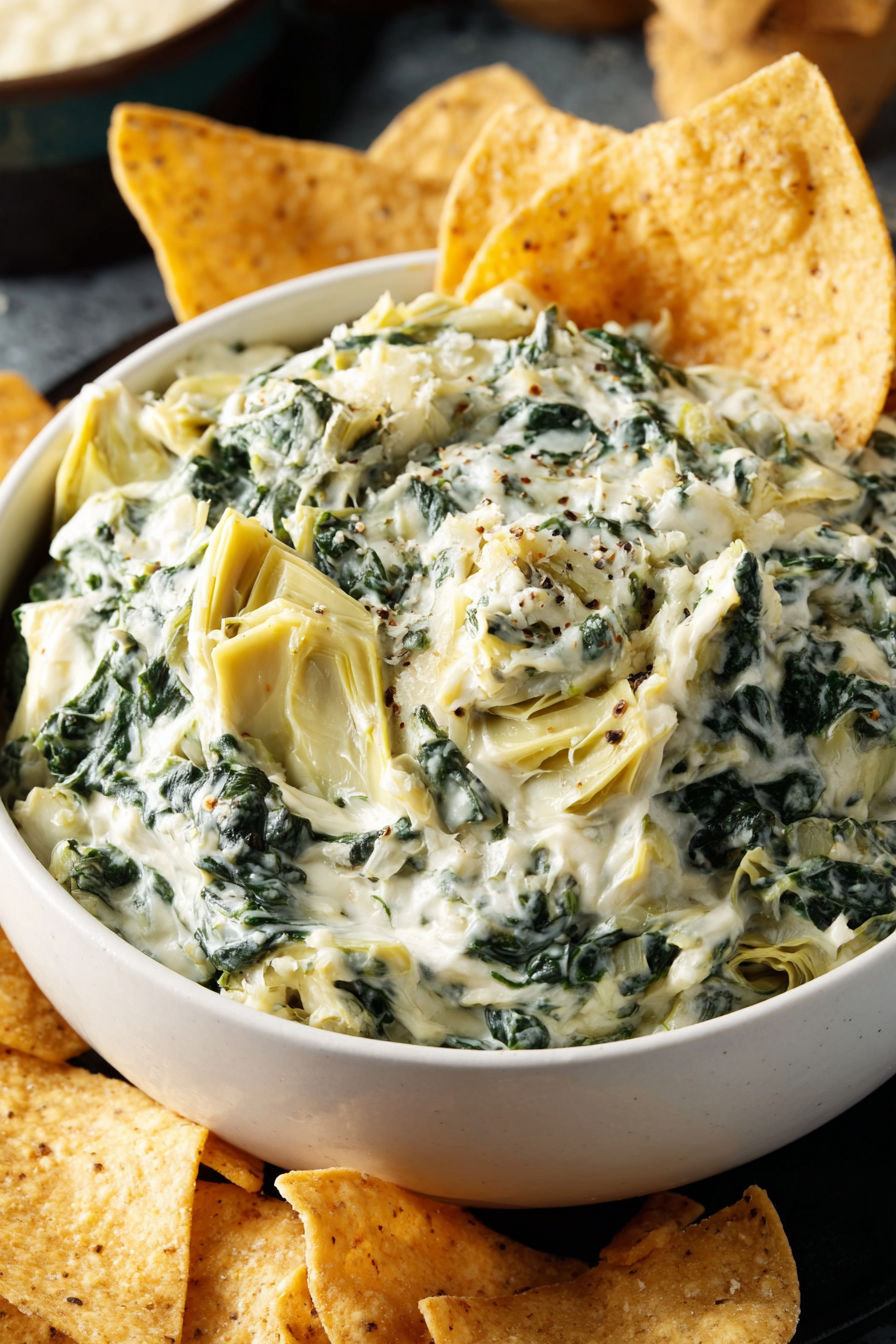 A bowl of food with a green leafy vegetable in it.