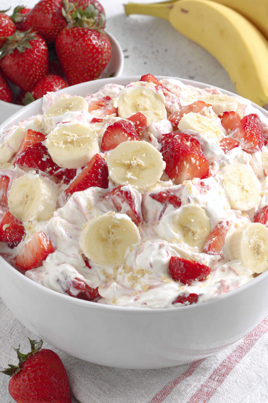 A bowl of strawberry banana cheesecake salad.