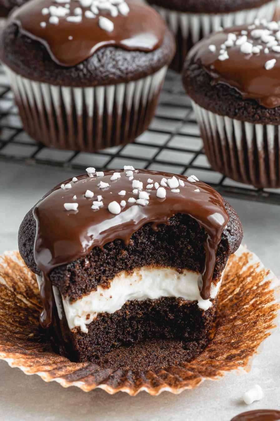 A chocolate cupcake with white frosting.