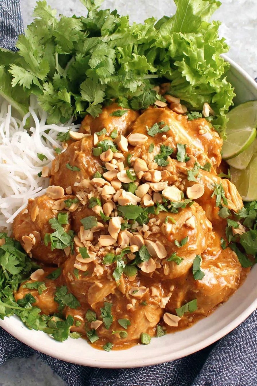 A bowl of food with peanuts and lime.