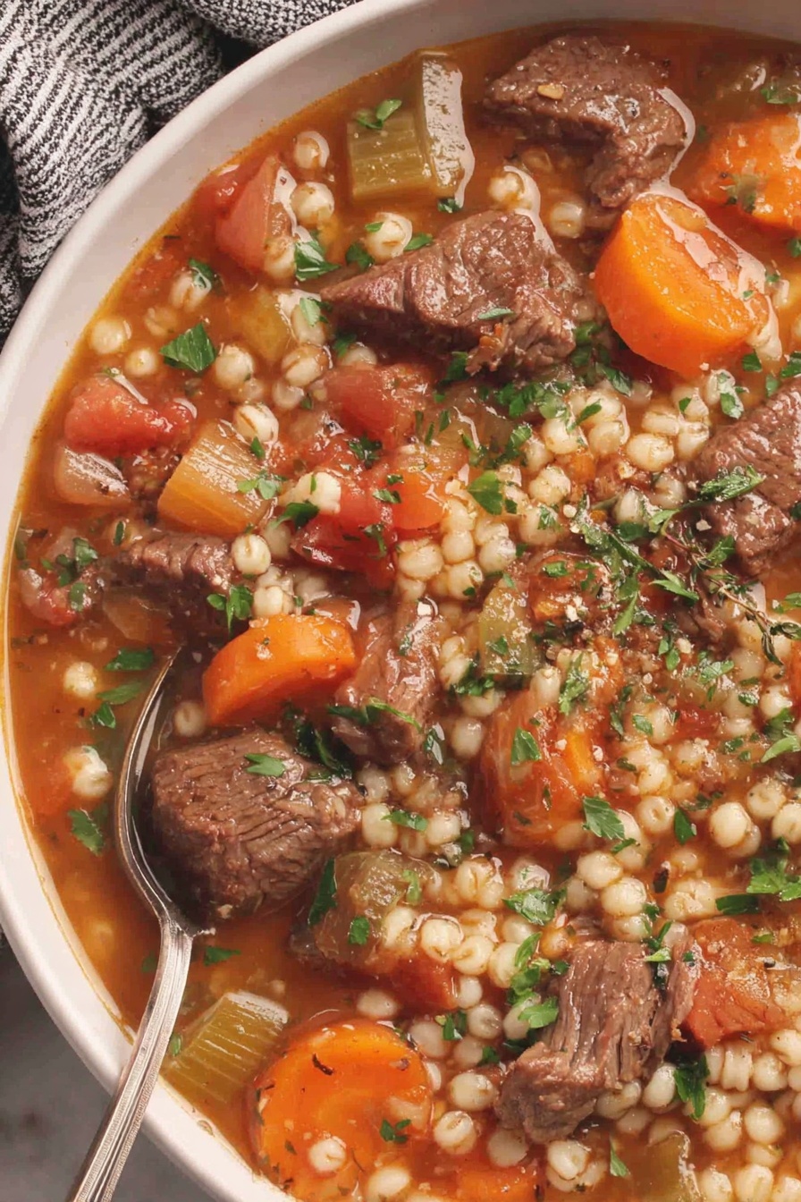A bowl of hearty beef and barley soup.
