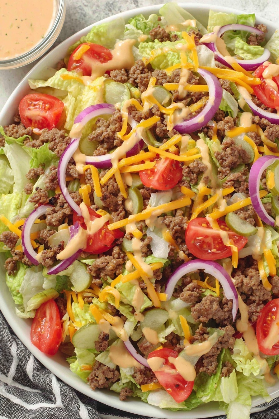 A close up of a salad with cheese and tomatoes.