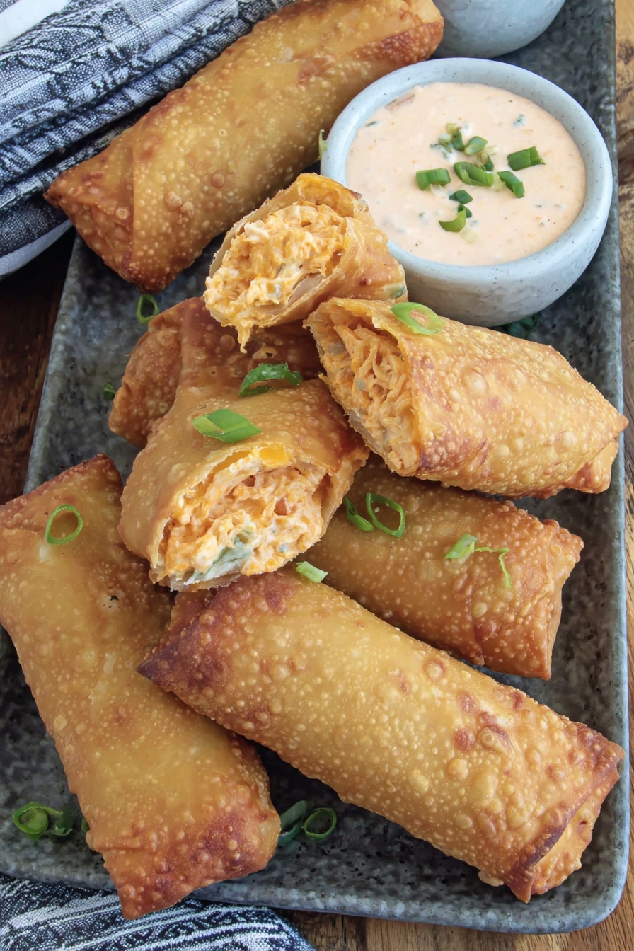 A plate of food with a bowl of sauce.