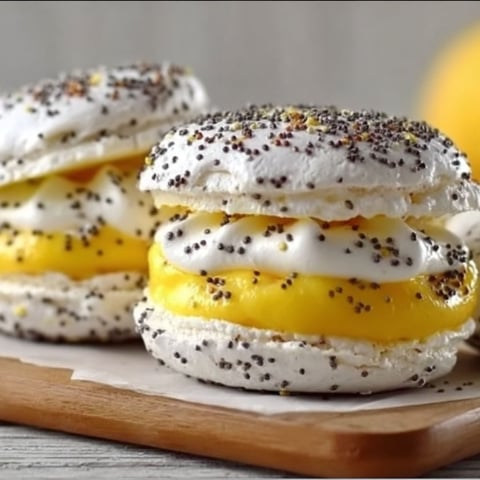 Two lemon and poppy seed meringue sandwiches.