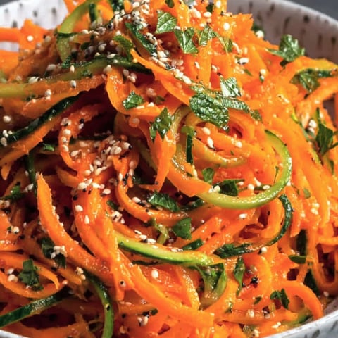 A bowl of cucumber carrot salad.