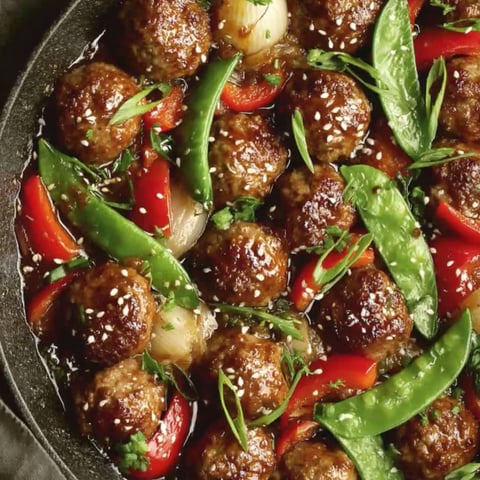 A bowl of meatballs with a sweet and savory sauce.