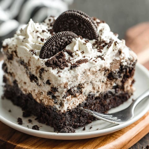 A slice of Oreo Poke Cake on a plate.